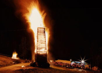 Der Funken in der Parzelle Kehlegg in Dornbirn im Vollbrand, rundherum Zuschauer:innen, die das traditionelle Funken-Abbrennen bestaunen