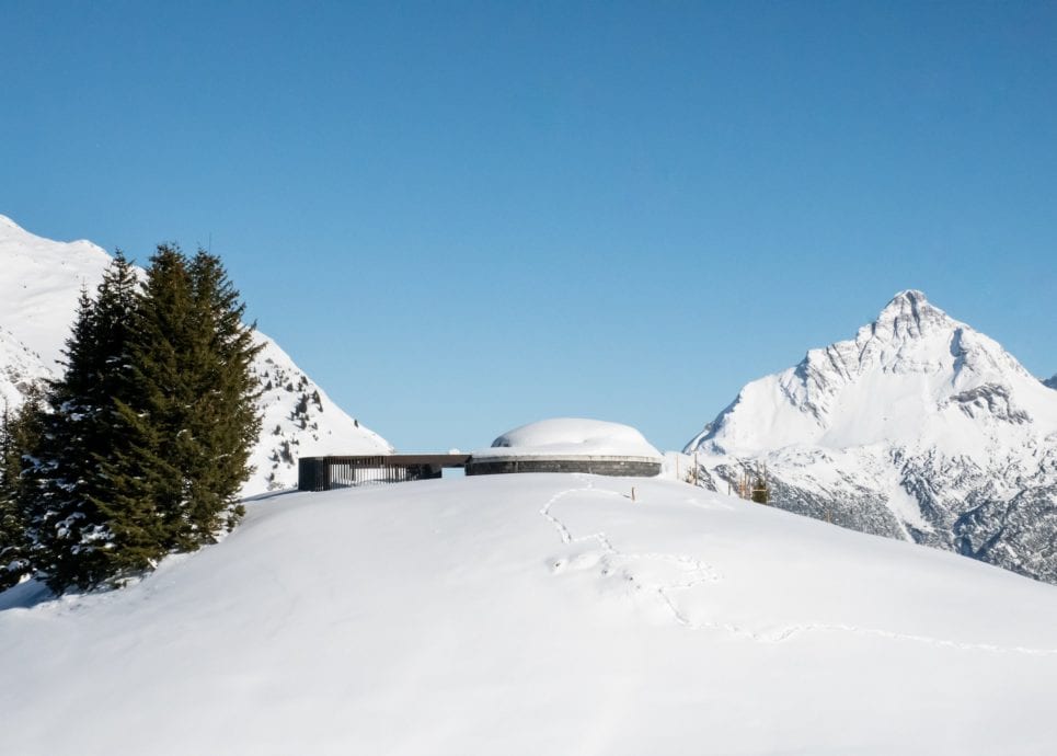 Skyspace Lech, von außen in tief verschneiter Umgebung, im Hintergrund der Berg Omeshorn