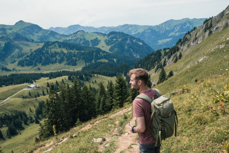 Yannik auf der Wanderung Berg Kanisfluh. Saftige grüne Wiesen und Hügel des Bregenzerwaldes umgeben ihn.
